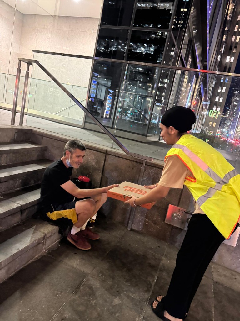 Volunteer offering a meal during night outreach
